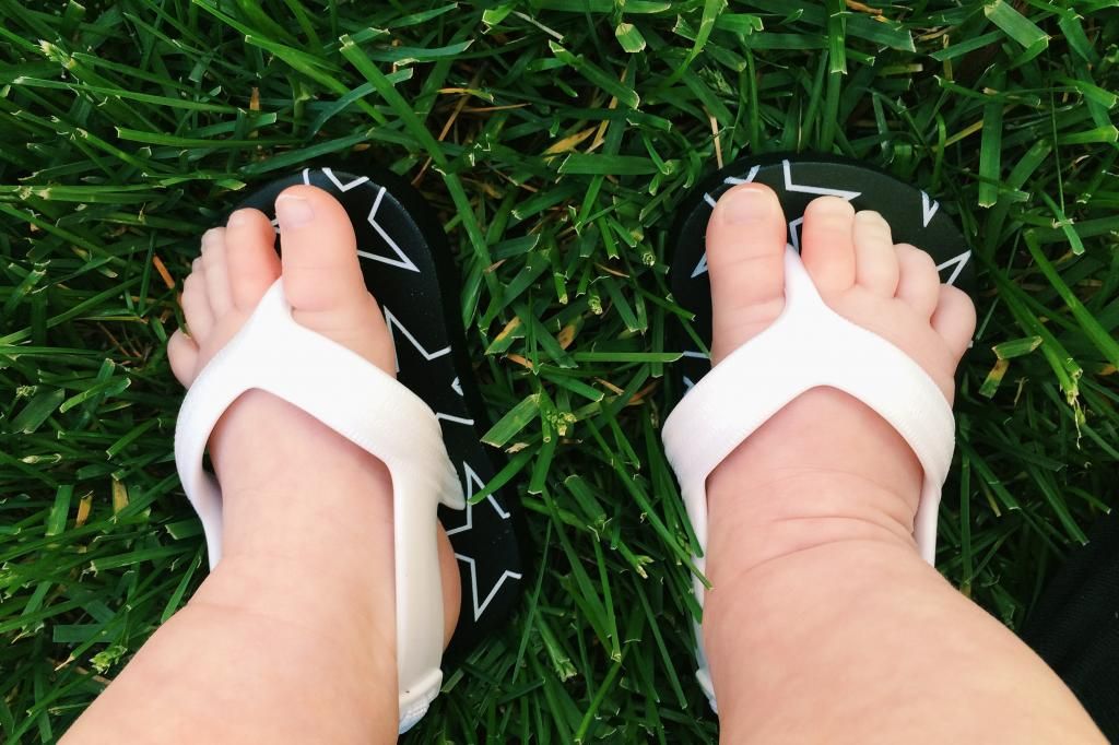 baby feet and baby flip-flops